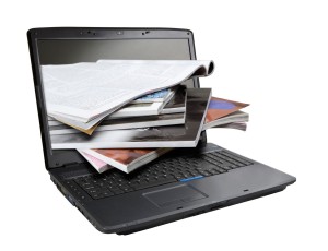 Laptop with books and documents emerging